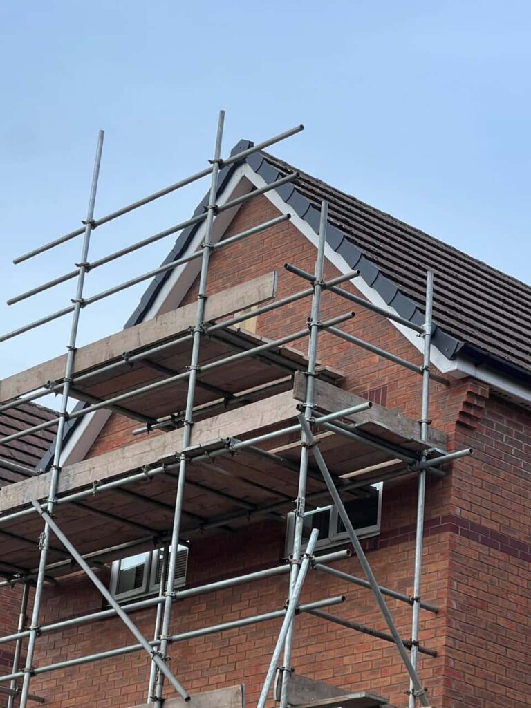 This is a photo of a roof which has just been repaired. There is a scaffold located at the gable end for access onto the roof. Works carried out by Bingham Roofing Repairs